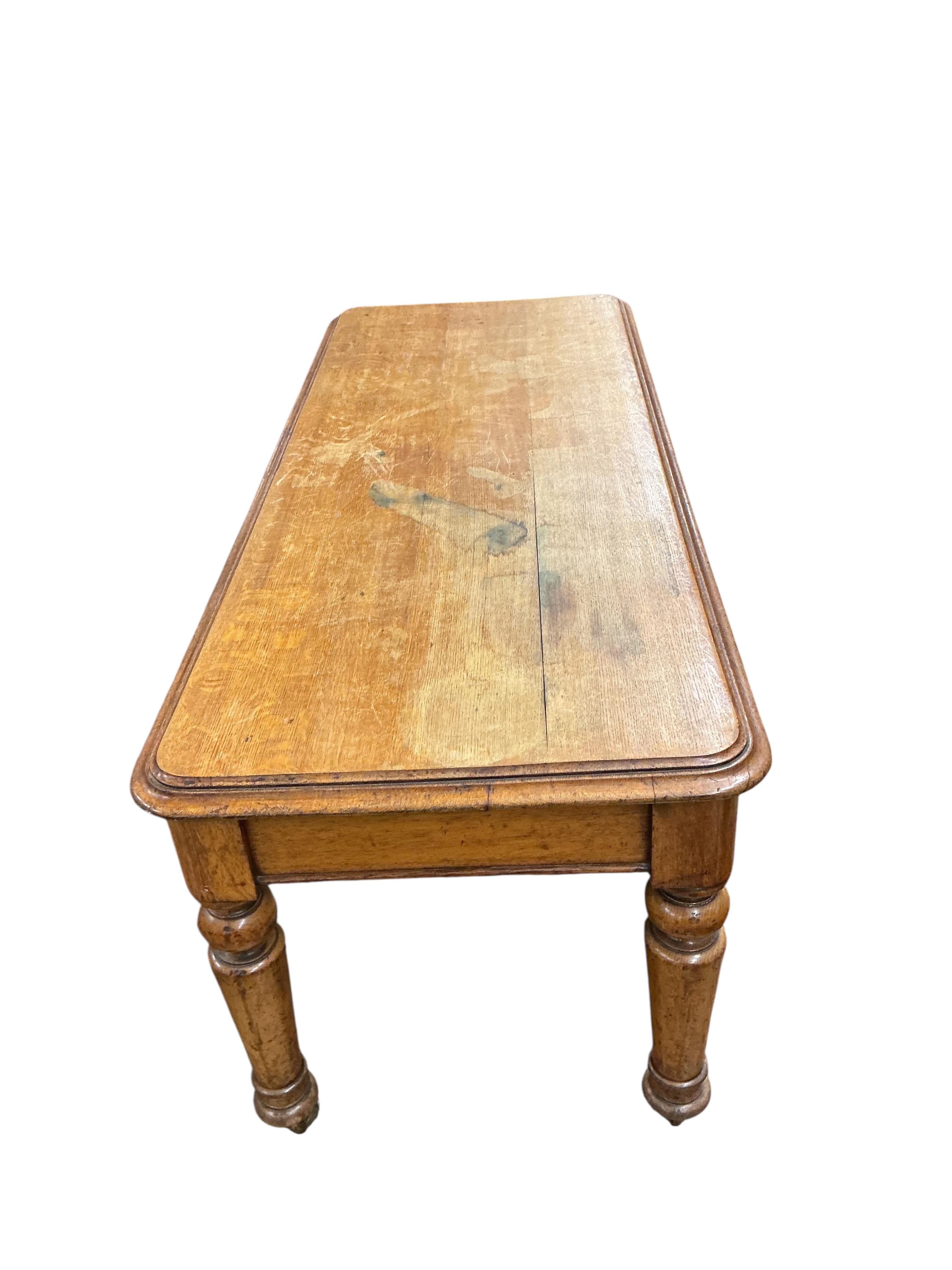 A Victorian light oak side table, fitted two drawers, on turned legs, width 180cm, depth 74cm, height 80cm